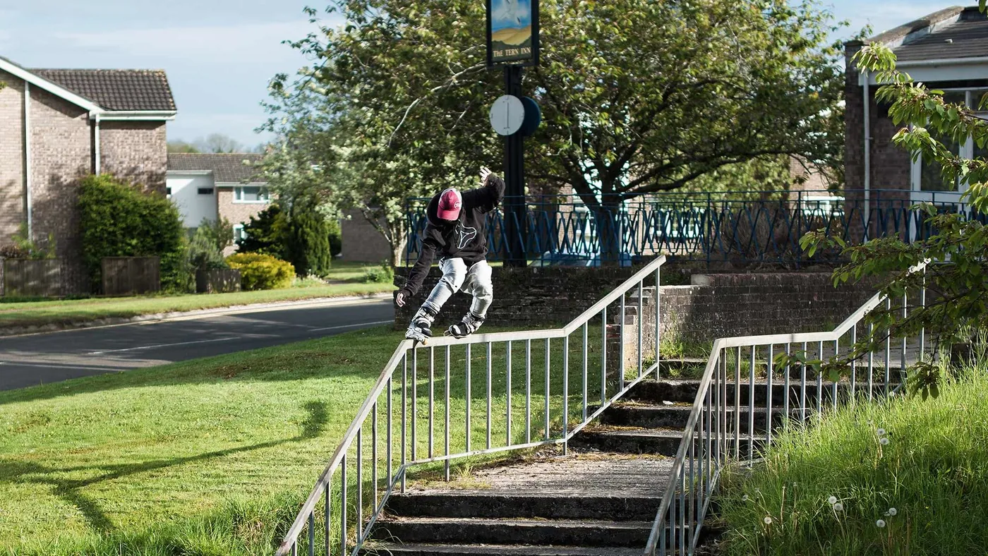 A skater grinding a handrail in ENIGMA MADE clothing